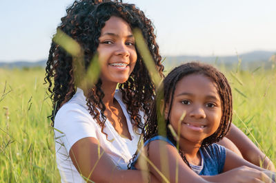 Portrait of smiling sisters outdoors