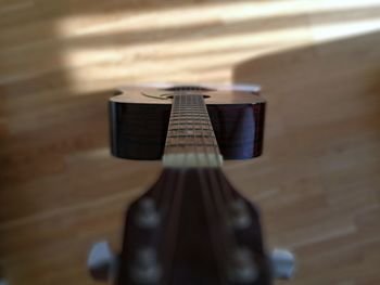 Directly above shot of guitar on hardwood floor