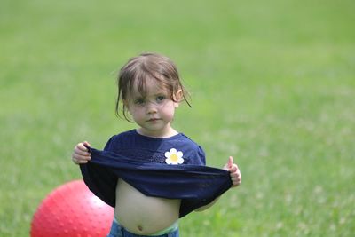 Thoughtful girl standing on field