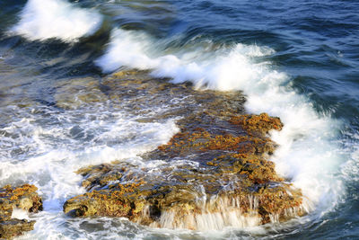 Waves splashing on rocks at shore