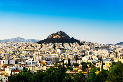 View of townscape against clear blue sky