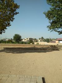 View of street by buildings against clear sky