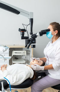 Side view of young man working at clinic