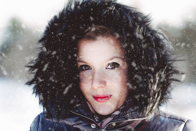 Portrait of smiling woman in snow