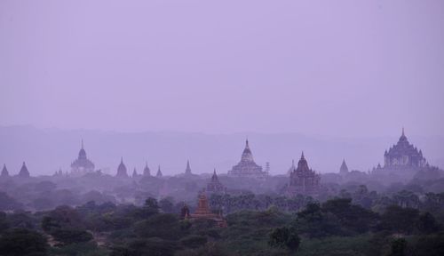 Buildings in city against clear sky