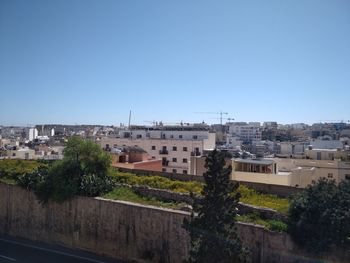 High angle view of townscape against clear blue sky