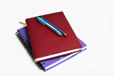 High angle view of pen on book against white background