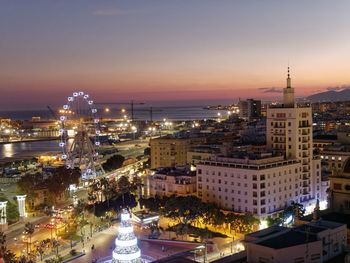 High angle view of illuminated city buildings at night