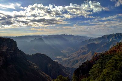 Scenic view of mountains against cloudy sky