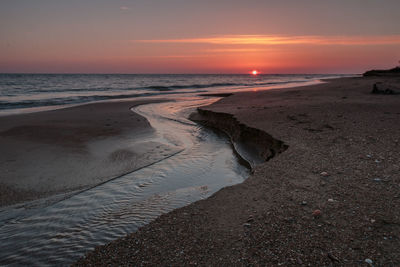 Scenic view of beach against sky during sunset