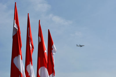 Low angle view of airplane flying against sky