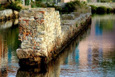 Old stone wall by river
