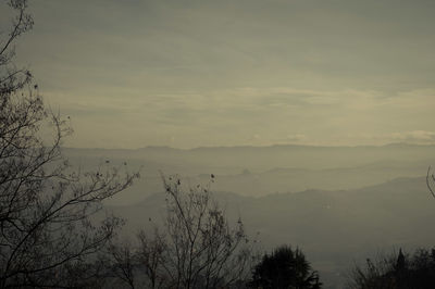 Scenic view of silhouette mountains against sky at sunset