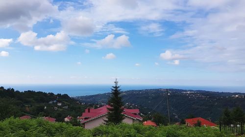 High angle view of houses and trees against sky