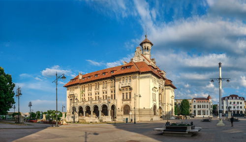 Panoramic view of buildings in city against sky