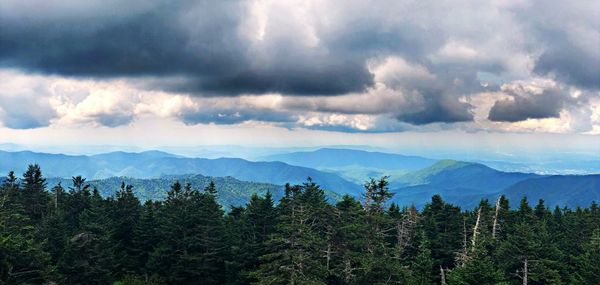 Scenic view of mountains against cloudy sky