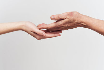 Cropped image of couple hands against white background