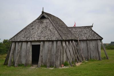 Exterior of house on field against sky