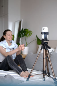 Portrait of young woman sitting at home