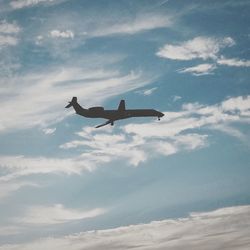 Low angle view of airplane flying in sky