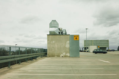 Road sign against sky