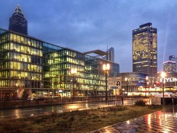 Reflection of illuminated buildings in city at night