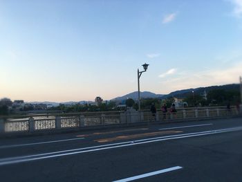 Empty road with mountains in background