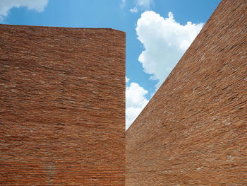 Low angle view of building against cloudy sky