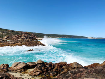 Scenic view of sea against clear blue sky