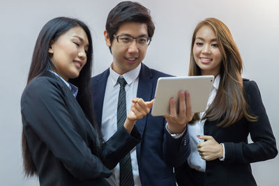 Smiling young woman using smart phone