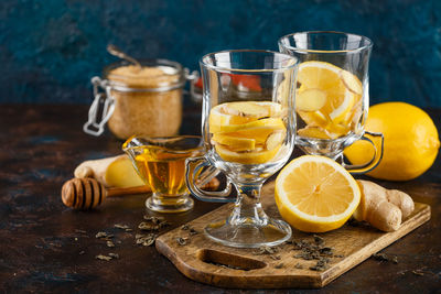 Glass of juice and glasses on table