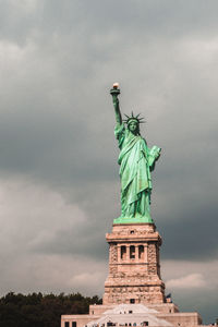 Low angle view of statue against cloudy sky