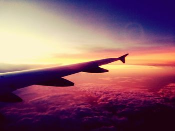 Cropped airplane flying over cloudscape