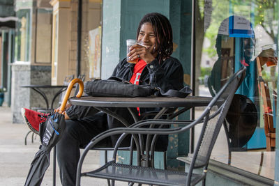 Man looking at camera while sitting on chair