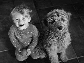 Portrait of cute boy playing with dog
