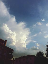 Low angle view of building against cloudy sky
