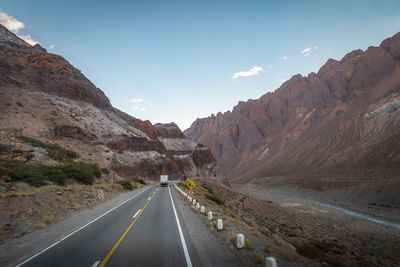 Road amidst mountains against sky