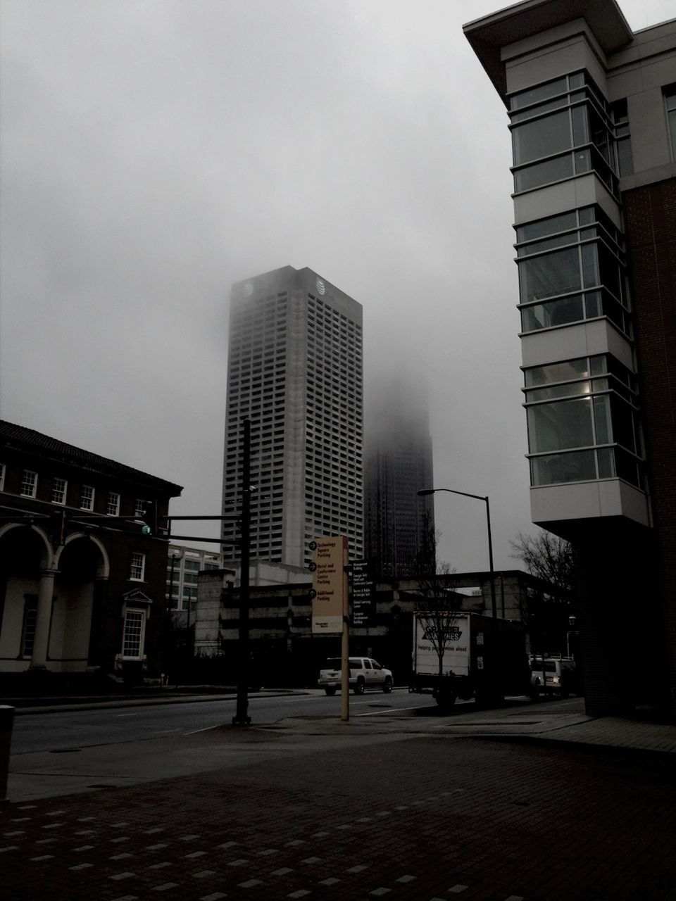 building exterior, architecture, built structure, city, sky, office building, building, skyscraper, street, modern, tower, tall - high, cloud - sky, road, city life, residential building, outdoors, residential structure, street light, day