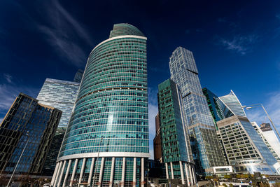 Low angle view of modern buildings against sky in city