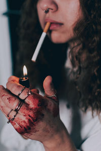 Close-up of hand holding cigarette