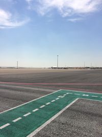 Empty runway against blue sky at airport