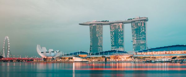 Illuminated city buildings against sky