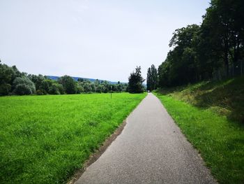Empty road along countryside landscape