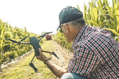 Man holding umbrella on field