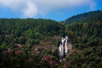 Scenic view of waterfall against sky