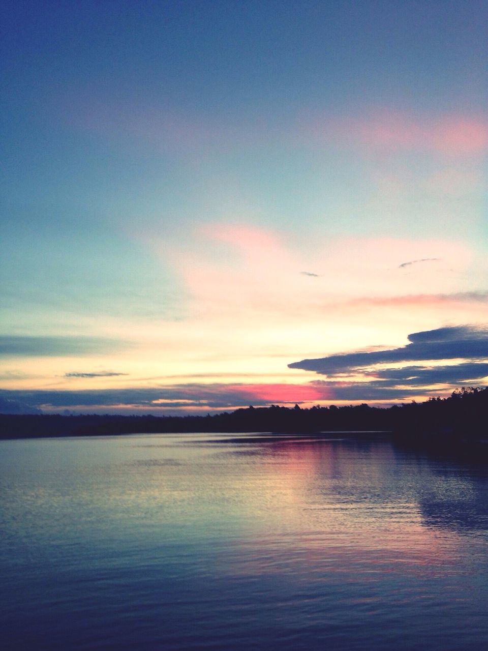 water, sunset, tranquil scene, scenics, tranquility, beauty in nature, waterfront, sky, reflection, idyllic, nature, orange color, calm, cloud - sky, blue, rippled, cloud, outdoors, no people, non-urban scene, remote, majestic, non urban scene