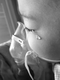 Little asian boy using disinfection cry with teardrop from sickness of lung disease in a hospital.