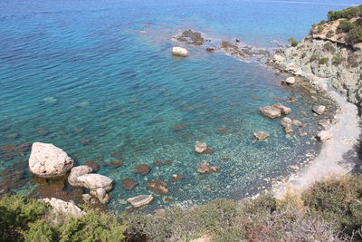 High angle view of rocks on sea shore