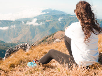 Woman sitting on mountain