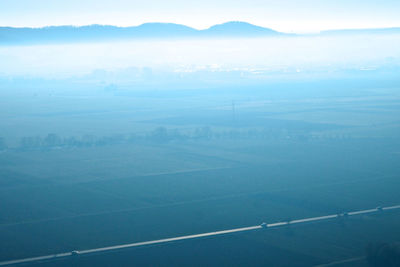 Aerial view of landscape and sea against sky